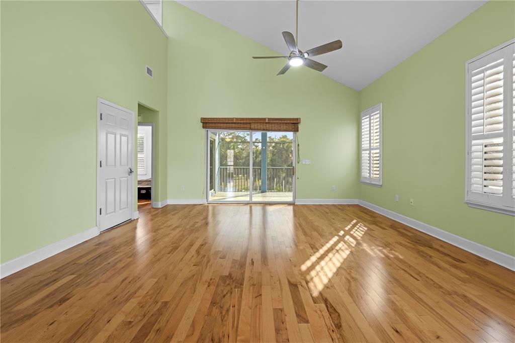 5446 Bluepoint Drive Port Richey, FL 34668 - Photo 34 of 68 a view of an empty room with wooden floor and a window