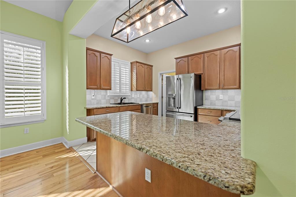 5446 Bluepoint Drive Port Richey, FL 34668 - Photo 38 of 68 a kitchen with a sink a counter top space cabinets and stainless steel appliances