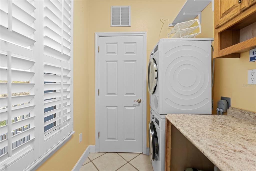 5446 Bluepoint Drive Port Richey, FL 34668 - Photo 40 of 68 a bathroom with a granite countertop sink and a mirror