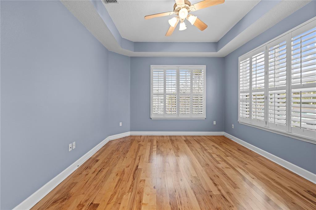 5446 Bluepoint Drive Port Richey, FL 34668 - Photo 45 of 68 a view of an empty room with wooden floor and a window