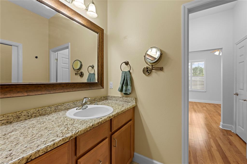 5446 Bluepoint Drive Port Richey, FL 34668 - Photo 48 of 68 a bathroom with a granite countertop sink and a mirror