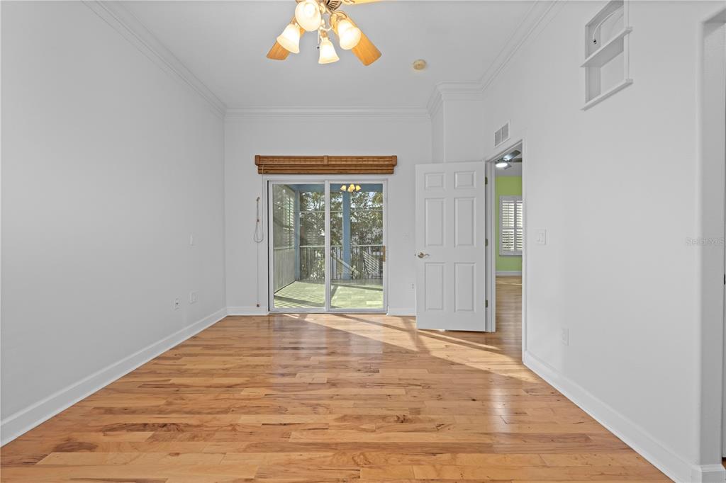 5446 Bluepoint Drive Port Richey, FL 34668 - Photo 51 of 68 a view of an empty room with wooden floor and a window