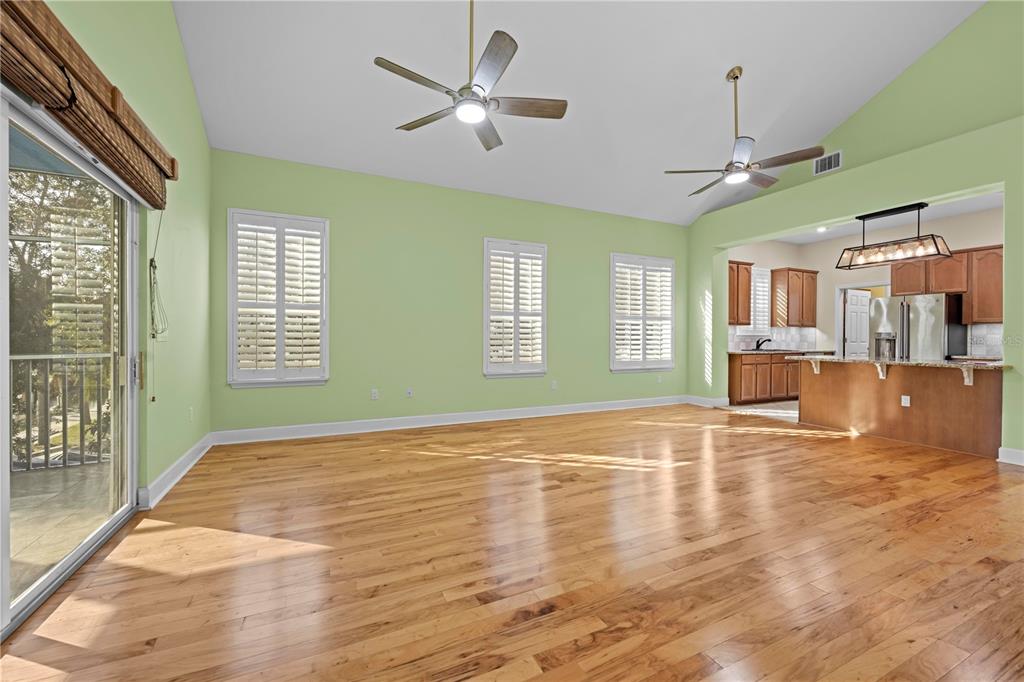 5446 Bluepoint Drive Port Richey, FL 34668 - Photo 53 of 68 a view of an empty room with window and wooden floor