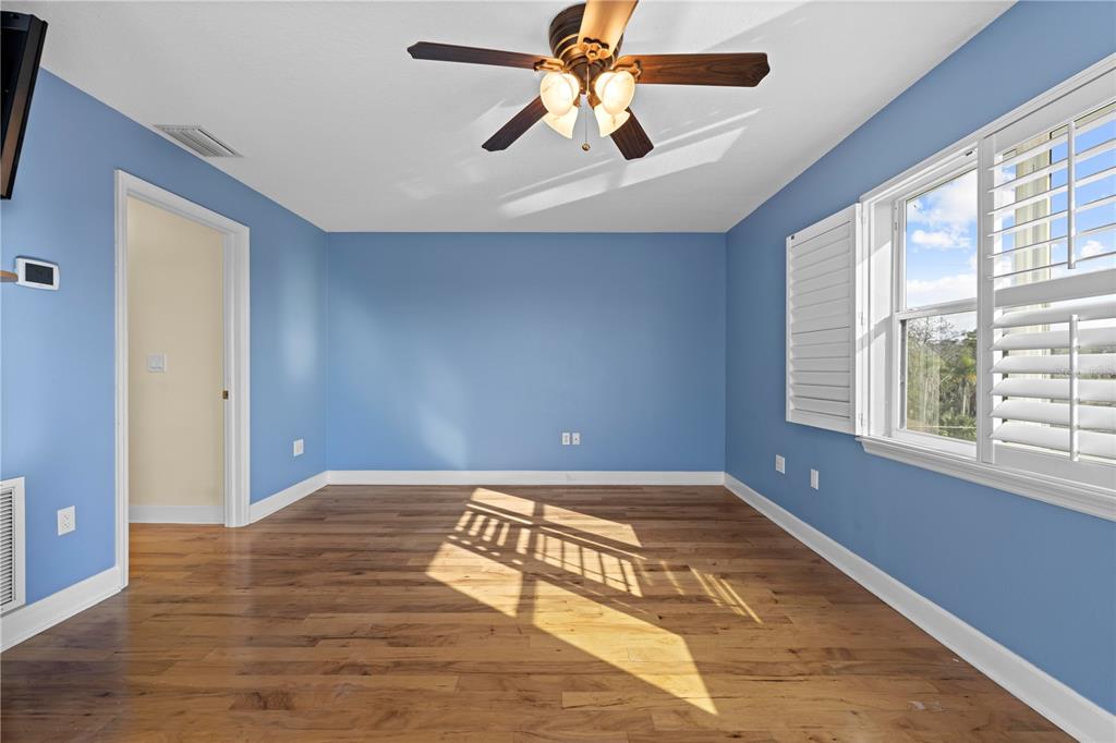 5446 Bluepoint Drive Port Richey, FL 34668 - Photo 55 of 68 a view of an empty room with window and wooden floor