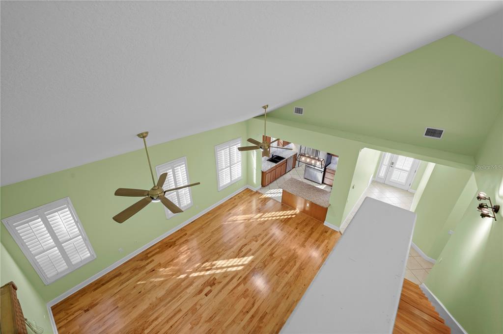 5446 Bluepoint Drive Port Richey, FL 34668 - Photo 67 of 68 a living room with a bed and a wooden floor