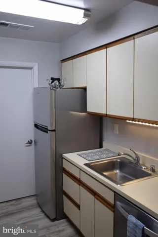 a kitchen with a sink and a refrigerator