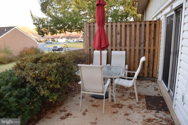 a view of a chairs and table in backyard