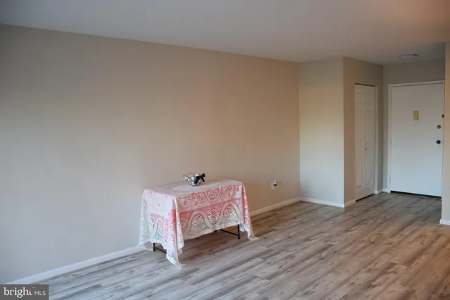 a room with wooden floor and hallway