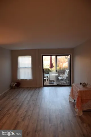 a view of a room with wooden floor and window