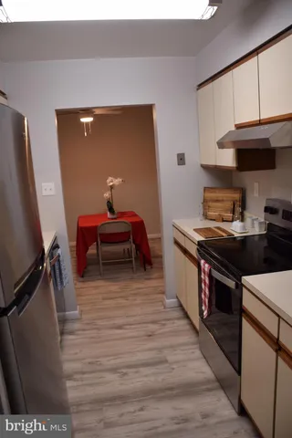 a kitchen with kitchen island a stove a sink and a refrigerator