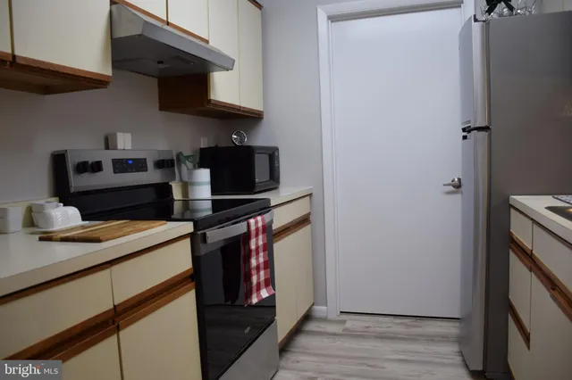 a kitchen with a stove and a refrigerator