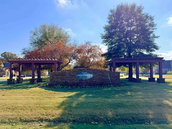 a front view of a building with a yard