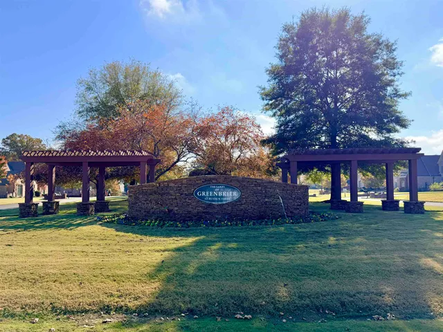 a front view of a building with a yard