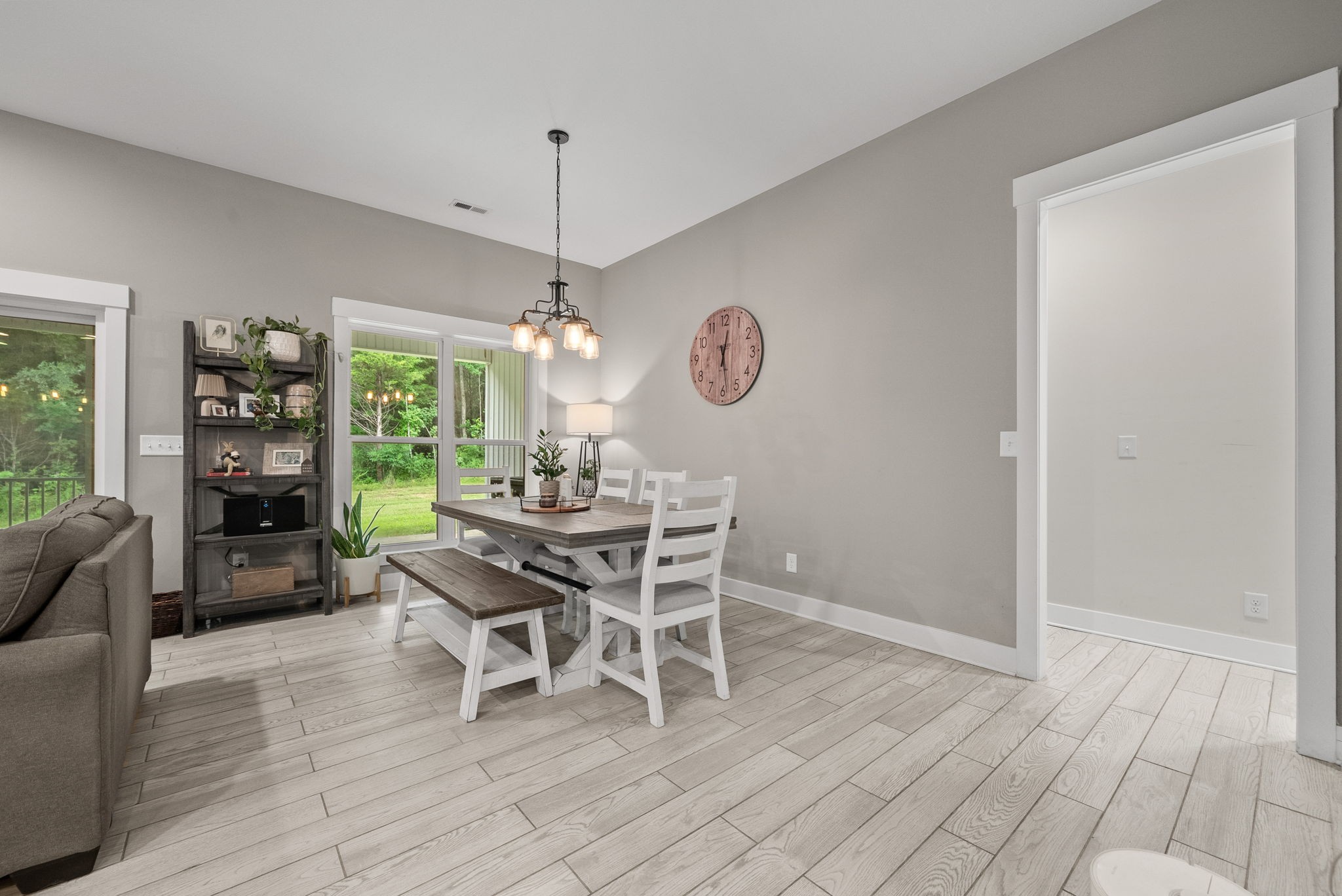 1895 Highway 13 Cunningham, TN 37052 - Photo 12 of 33 a dining room with wooden floor a chandelier a glass table and chairs