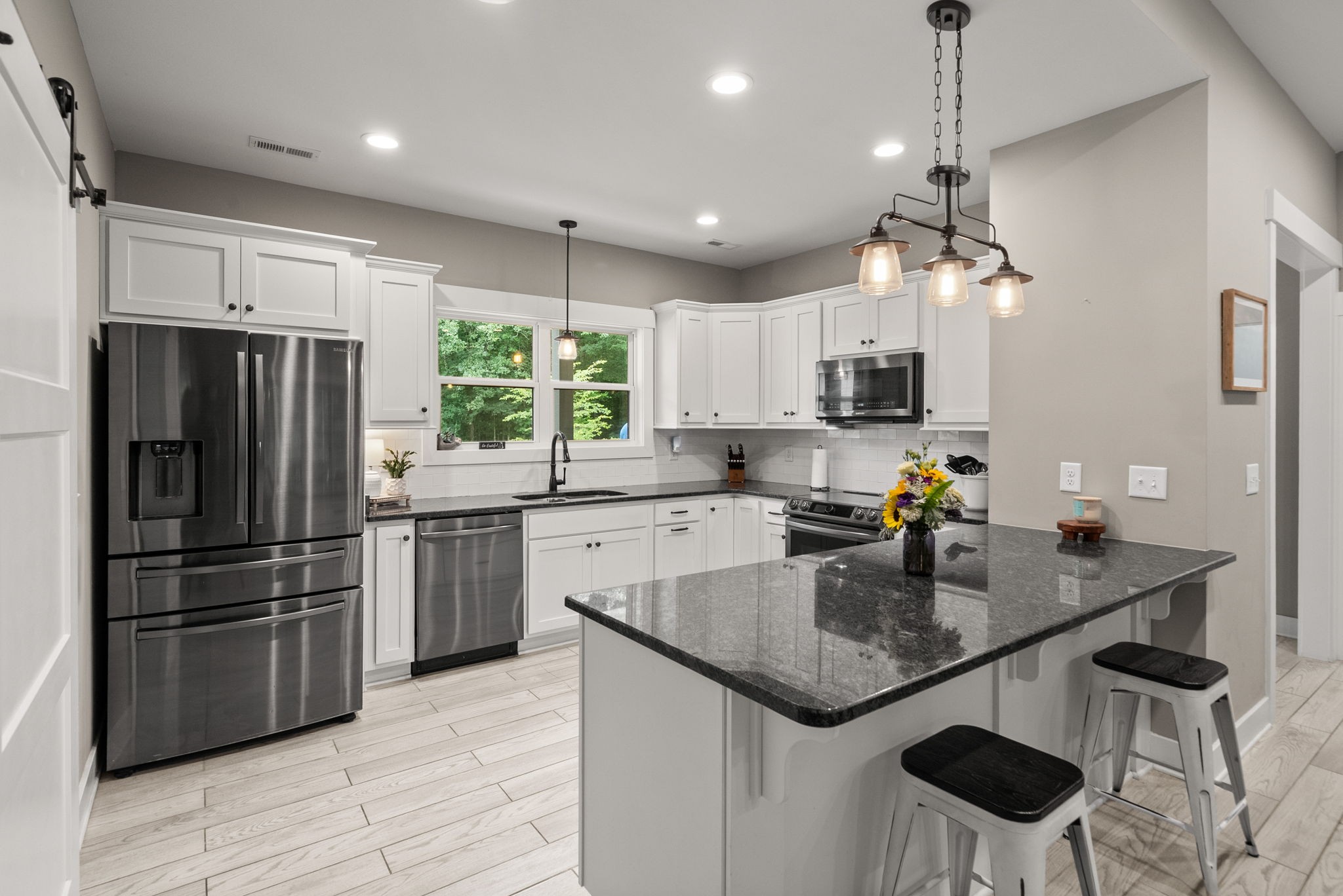 1895 Highway 13 Cunningham, TN 37052 - Photo 2 of 33 a kitchen with stainless steel appliances granite countertop a sink refrigerator and microwave