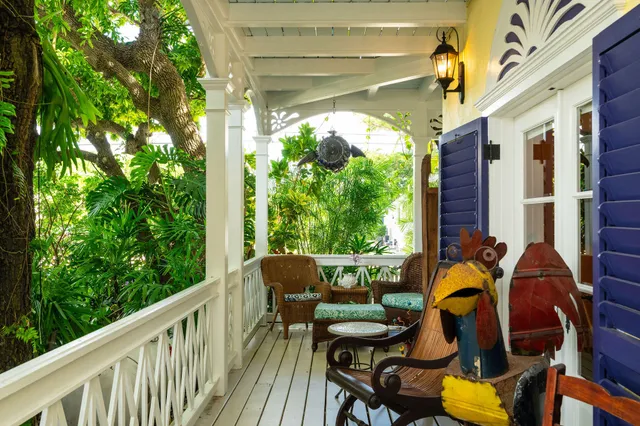 a bathroom with a sink a vanity and a large mirror next to a window
