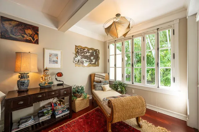 a bedroom with a bed and large window with balcony view