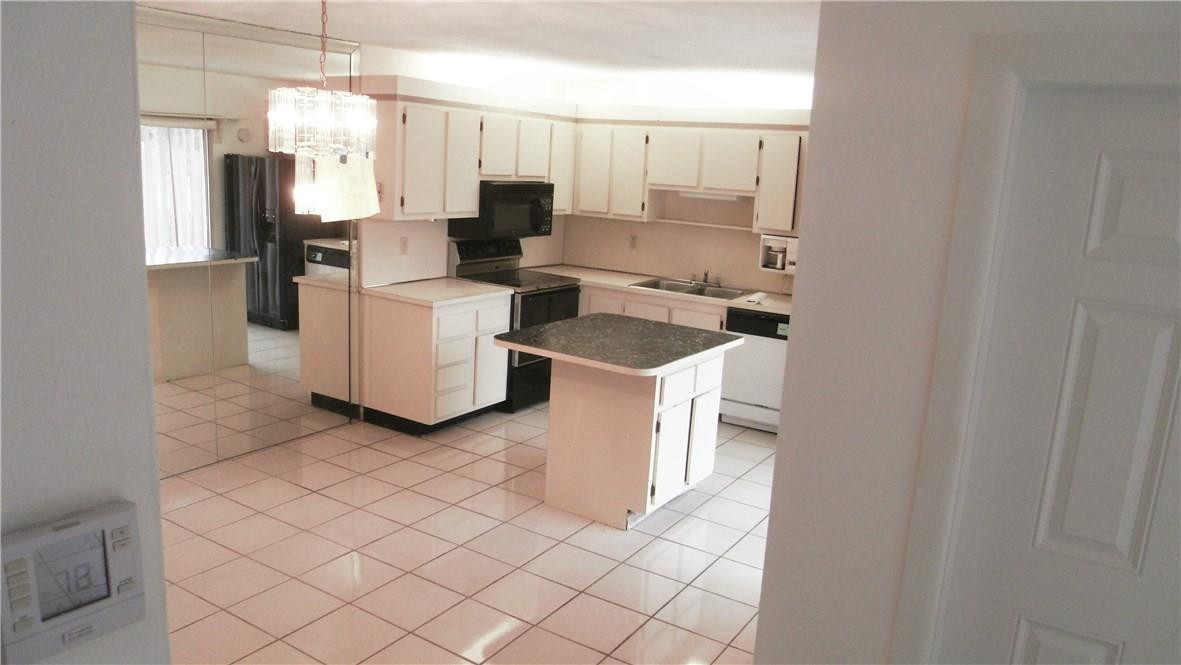 22188 Boca Rancho Drive, Unit D Boca Raton, FL 33428 - Photo 16 of 22 a kitchen with a sink cabinets and window