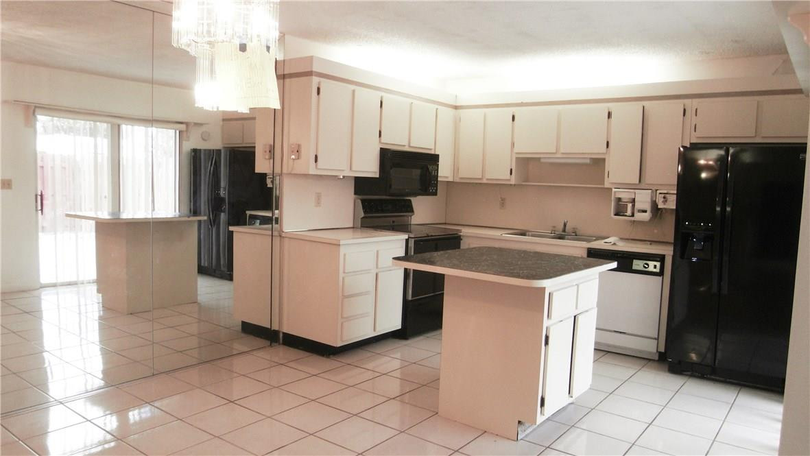 22188 Boca Rancho Drive, Unit D Boca Raton, FL 33428 - Photo 17 of 22 a kitchen with a stove sink and refrigerator