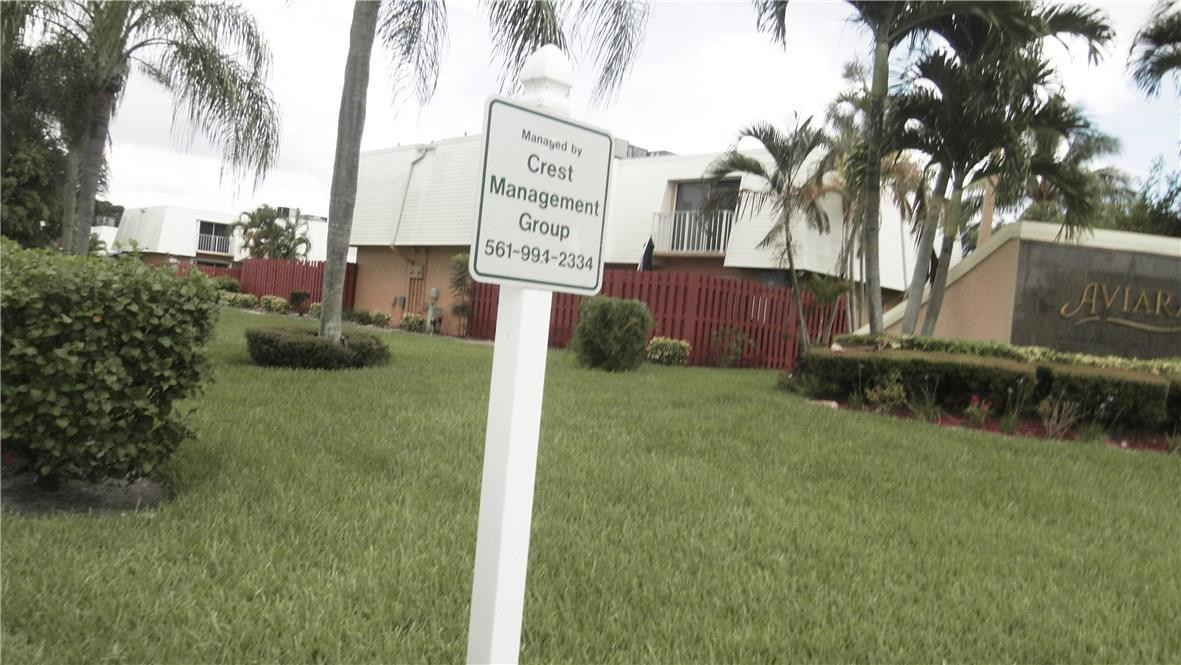 22188 Boca Rancho Drive, Unit D Boca Raton, FL 33428 - Photo 3 of 22 a backyard of a house with lots of green space and fountain