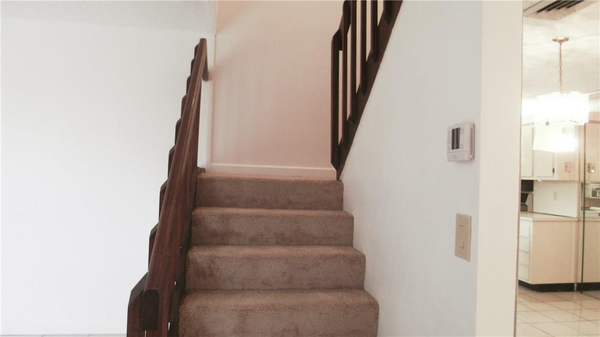 22188 Boca Rancho Drive, Unit D Boca Raton, FL 33428 - Photo 8 of 22 a view of staircase with white walls
