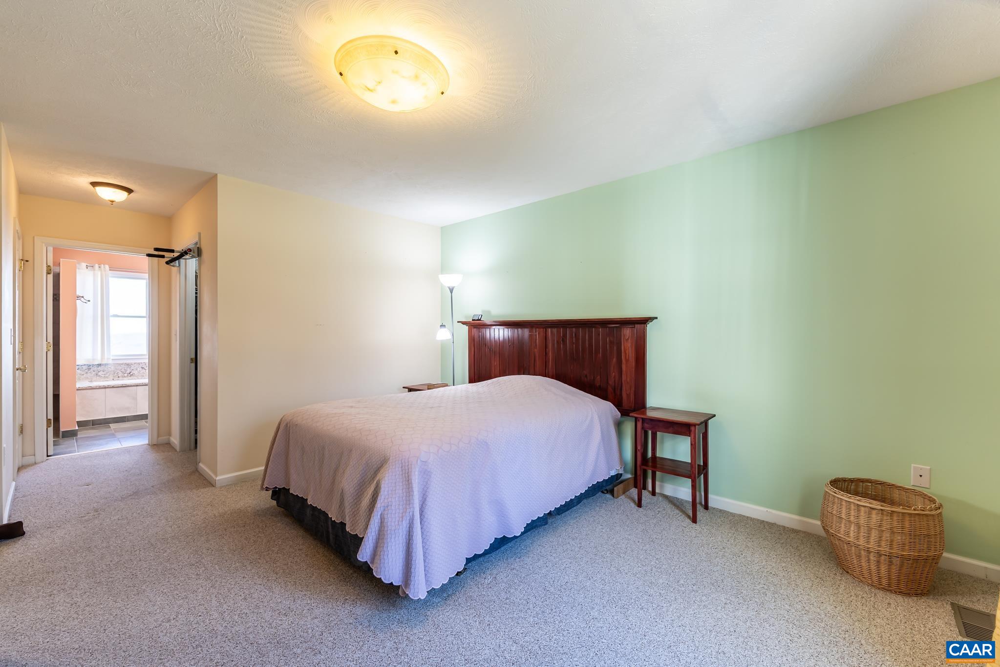 654 Saddleback Road Stanardsville, VA 22973 - Photo 22 of 75 a bedroom with a bed and a cabinets