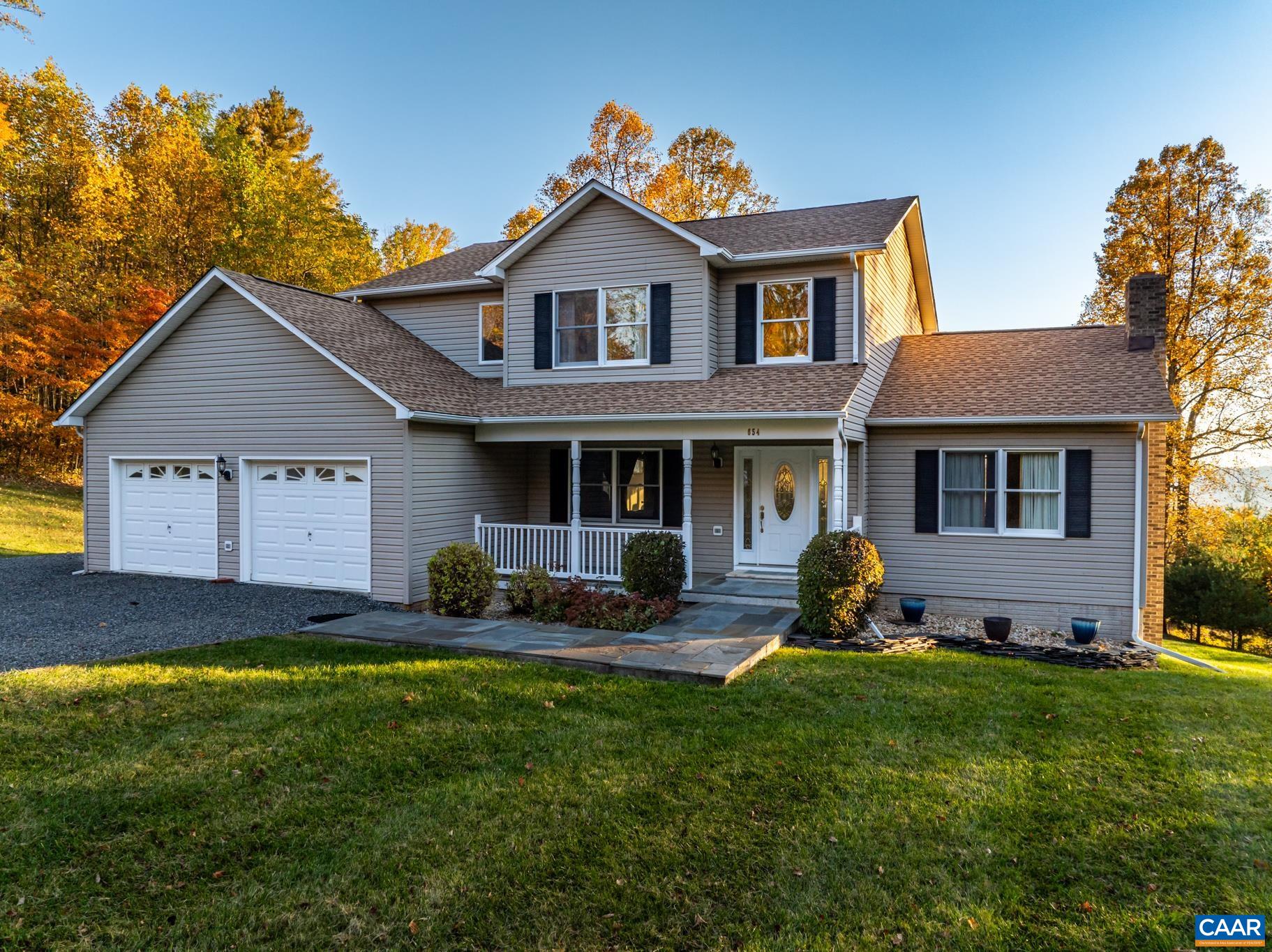 654 Saddleback Road Stanardsville, VA 22973 - Photo 3 of 75 a front view of a house with a yard and garage