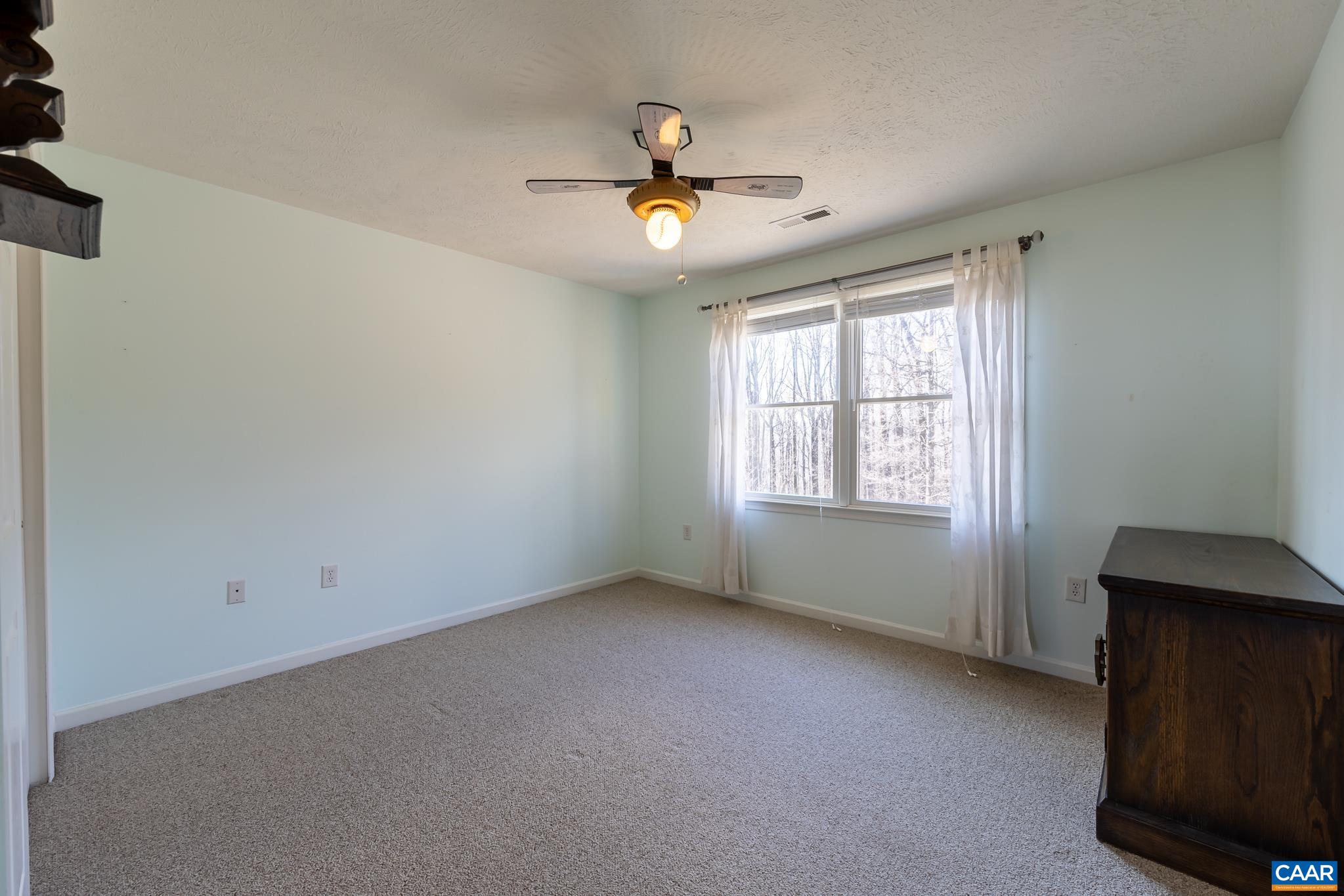 654 Saddleback Road Stanardsville, VA 22973 - Photo 36 of 75 an empty room with ceiling fan and window