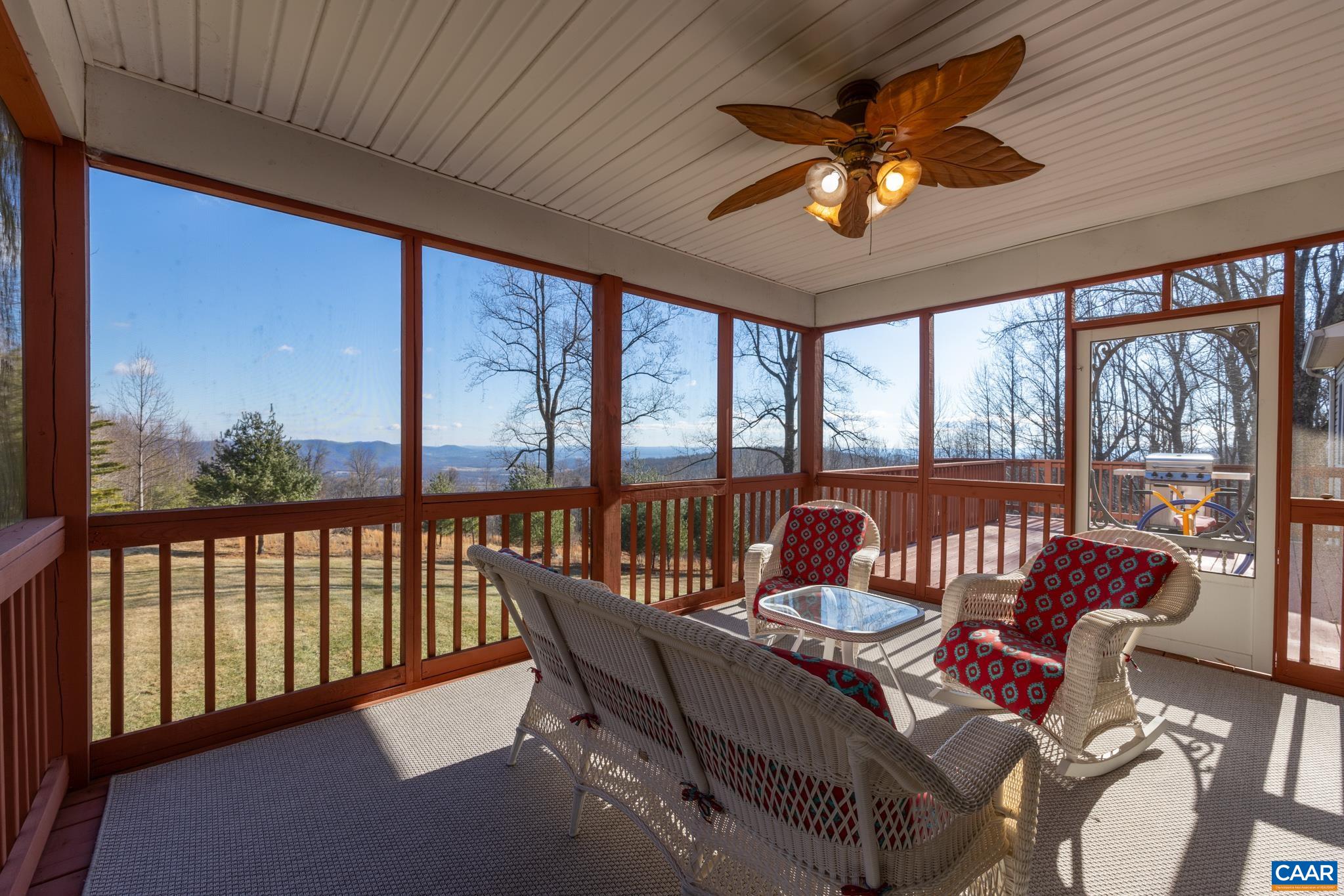 654 Saddleback Road Stanardsville, VA 22973 - Photo 8 of 75 a dining room with furniture a chandelier and a floor to ceiling window