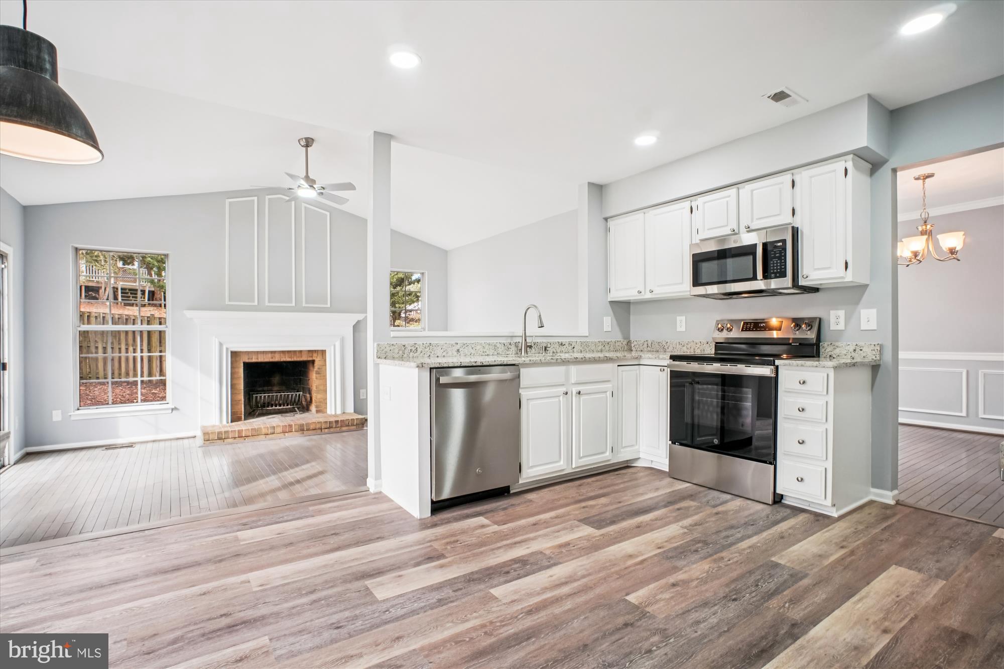 12318 Valley High Road Herndon, VA 20170 - Photo 18 of 56 a kitchen with granite countertop a stove top oven and refrigerator