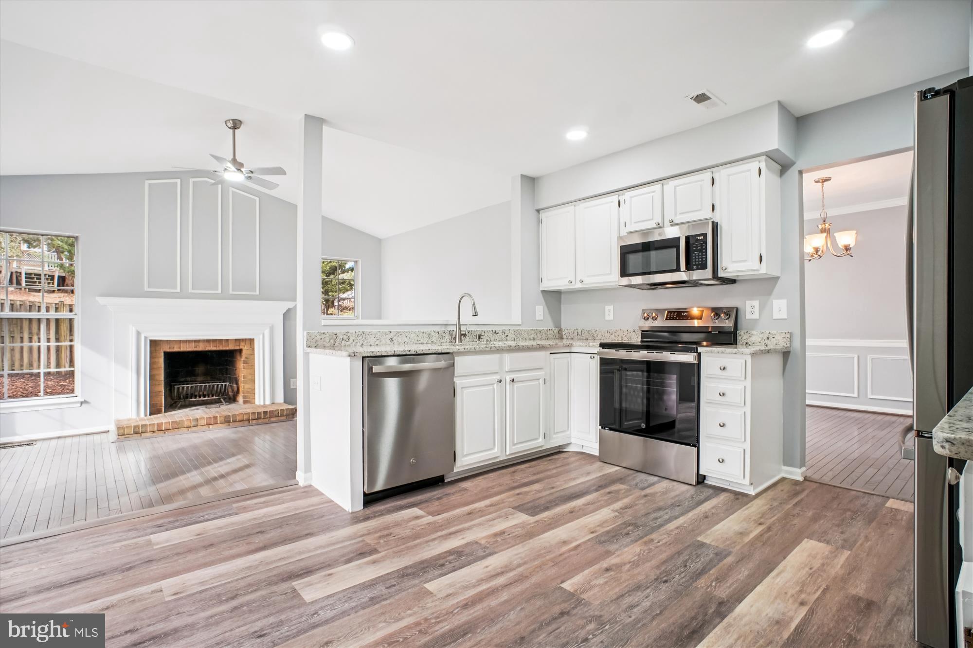 12318 Valley High Road Herndon, VA 20170 - Photo 19 of 56 a kitchen with granite countertop a refrigerator stove and oven