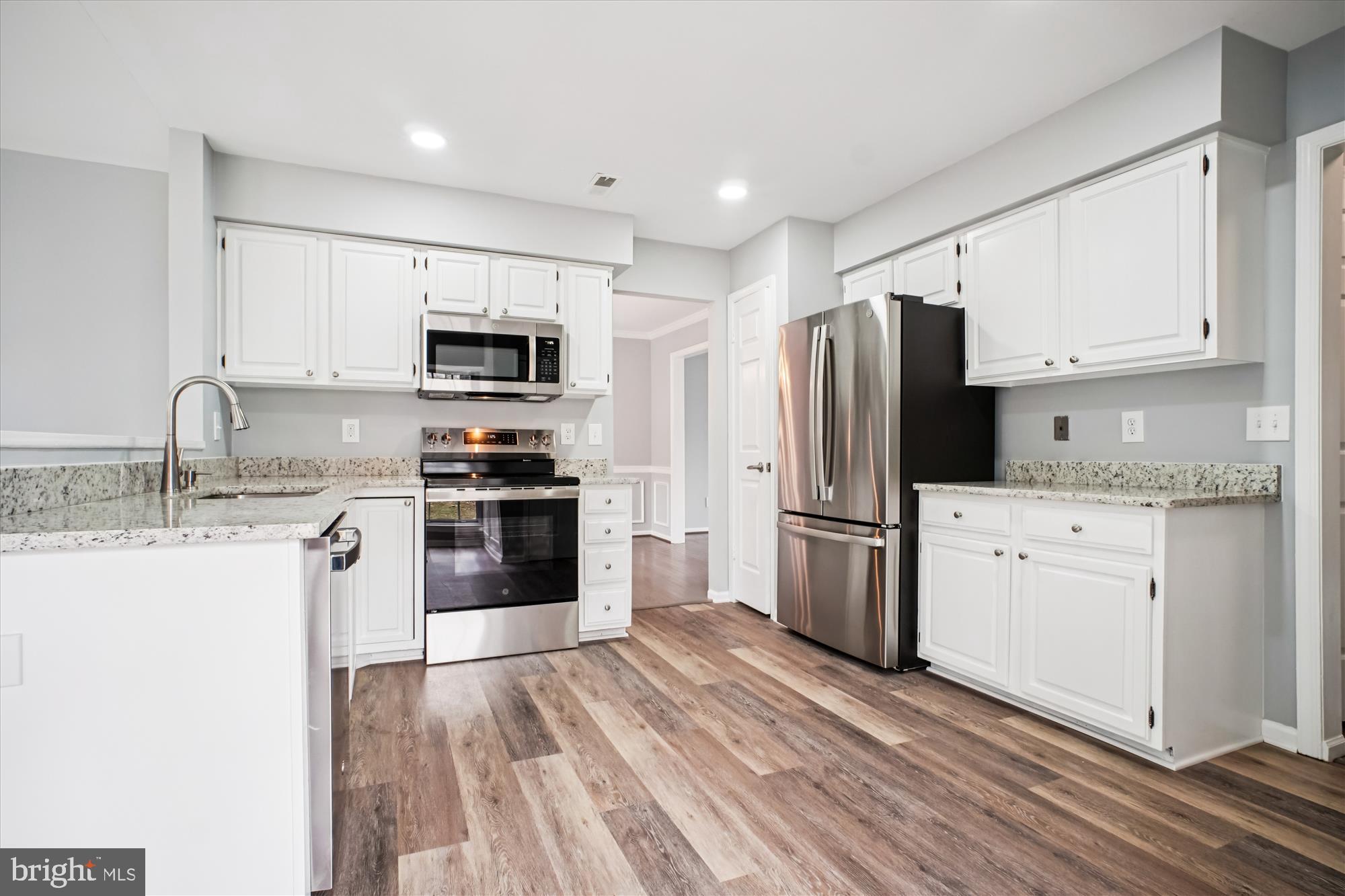 12318 Valley High Road Herndon, VA 20170 - Photo 20 of 56 a kitchen with a refrigerator stove and microwave