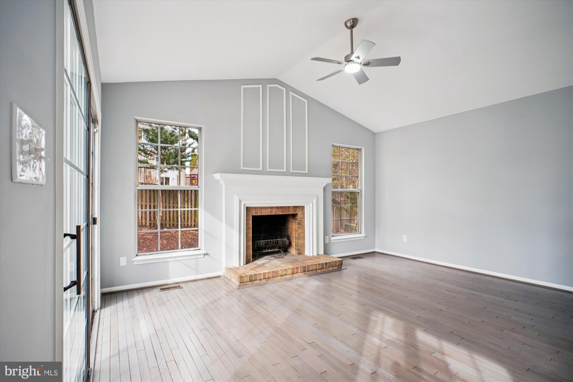12318 Valley High Road Herndon, VA 20170 - Photo 25 of 56 wooden floor fireplace and windows in an empty room