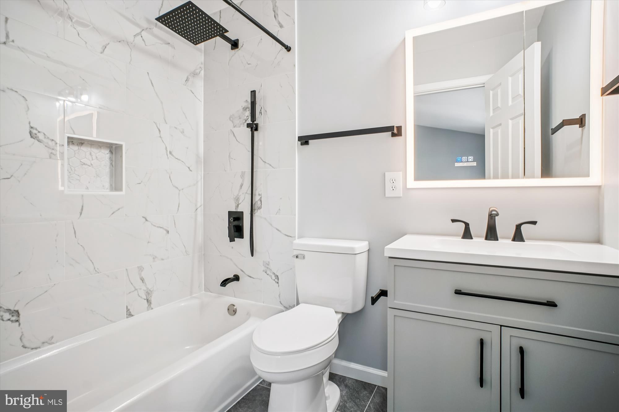 12318 Valley High Road Herndon, VA 20170 - Photo 31 of 56 a bathroom with a sink a toilet and a bathtub