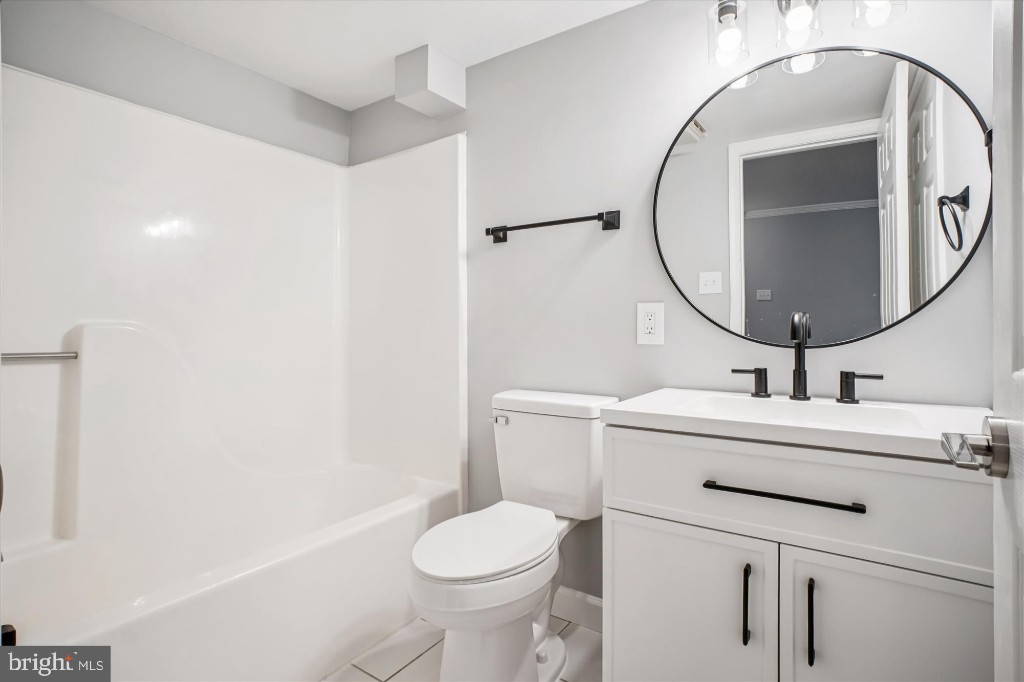 12318 Valley High Road Herndon, VA 20170 - Photo 42 of 56 a bathroom with a sink mirror vanity and toilet