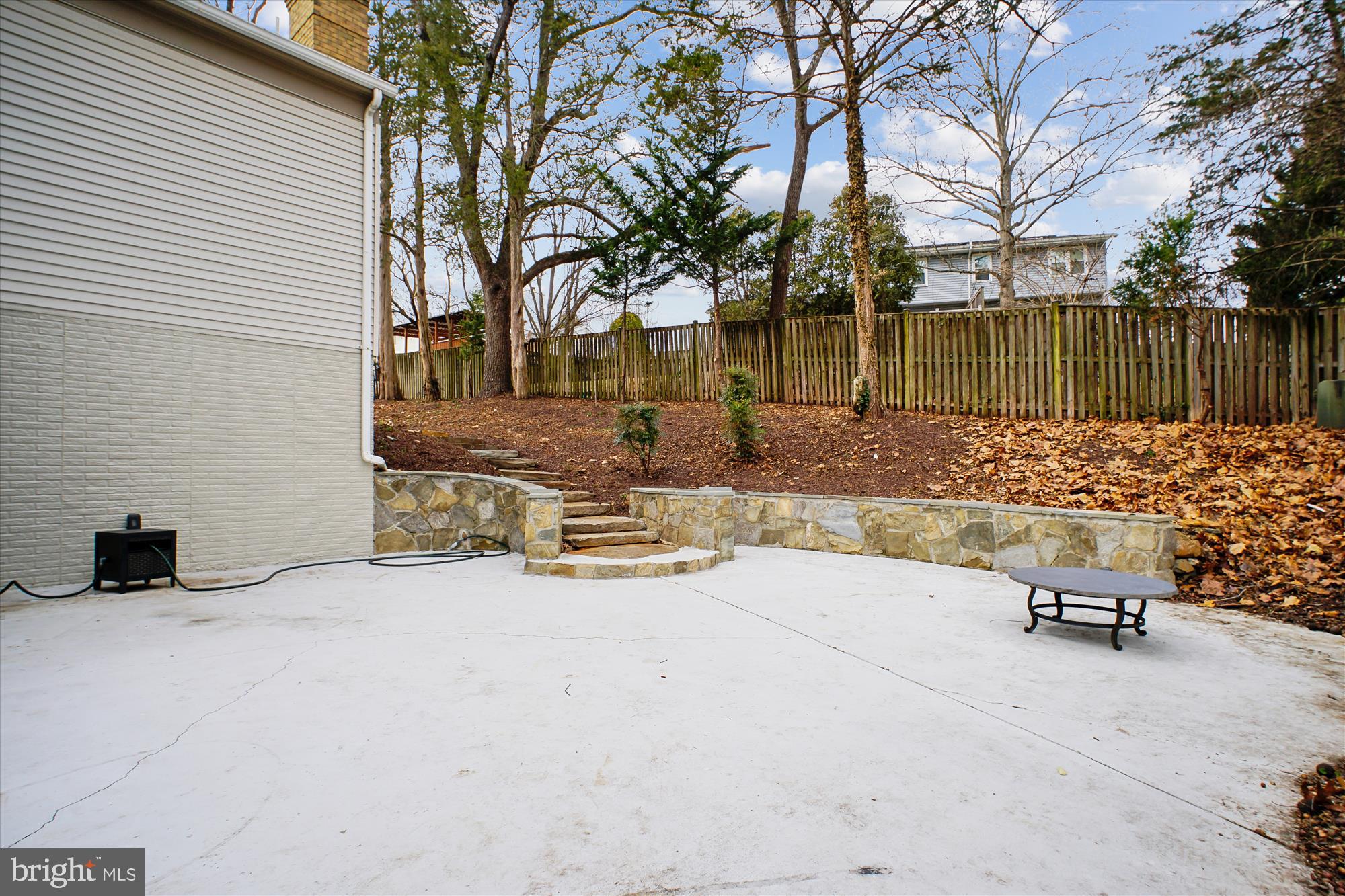 12318 Valley High Road Herndon, VA 20170 - Photo 48 of 56 a view of backyard with table and chairs and a large tree