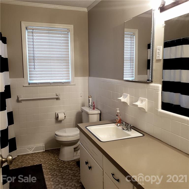 502 Roy Eaker Road Cherryville, NC 28021 - Photo 11 of 22 a bathroom with a sink a toilet and a window