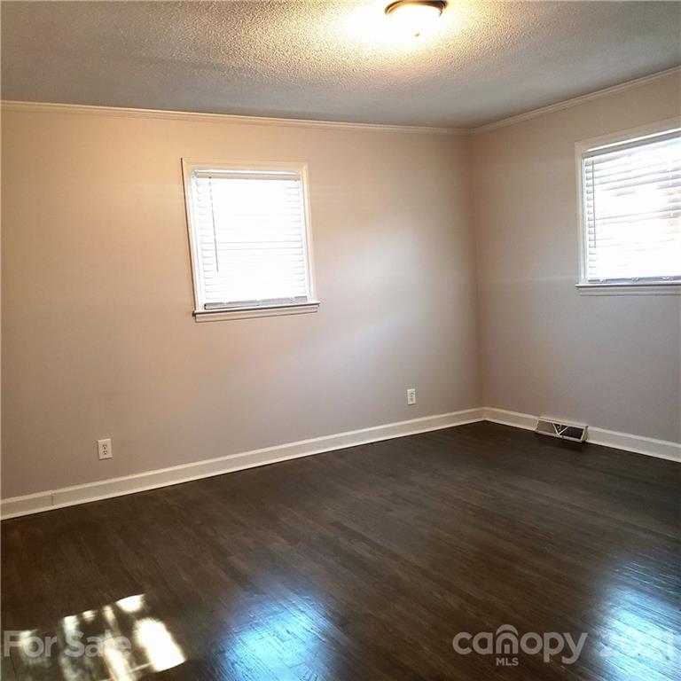 502 Roy Eaker Road Cherryville, NC 28021 - Photo 13 of 22 a view of an empty room with wooden floor and a window