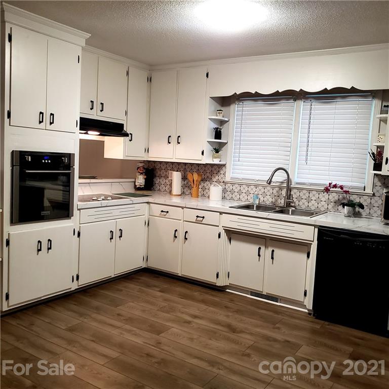 502 Roy Eaker Road Cherryville, NC 28021 - Photo 7 of 22 a white kitchen with granite countertop white cabinets and white appliances