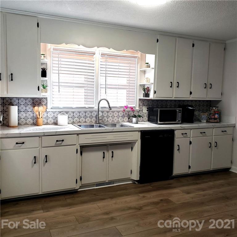 502 Roy Eaker Road Cherryville, NC 28021 - Photo 8 of 22 a kitchen with stainless steel appliances granite countertop a sink dishwasher a stove and a refrigerator