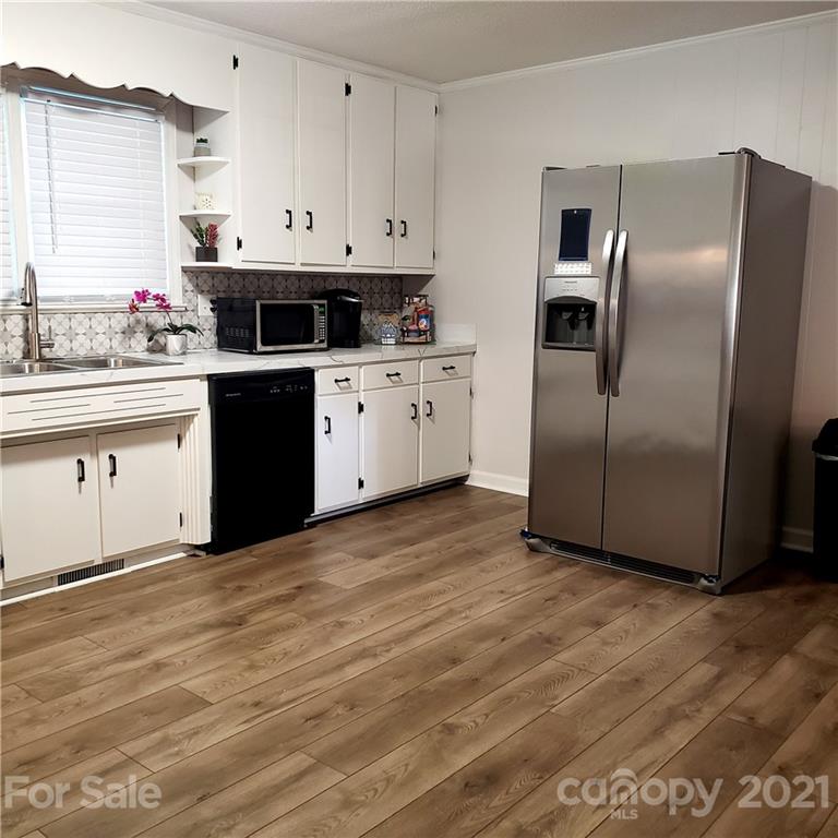 502 Roy Eaker Road Cherryville, NC 28021 - Photo 9 of 22 a kitchen with stainless steel appliances granite countertop a refrigerator sink and white cabinets