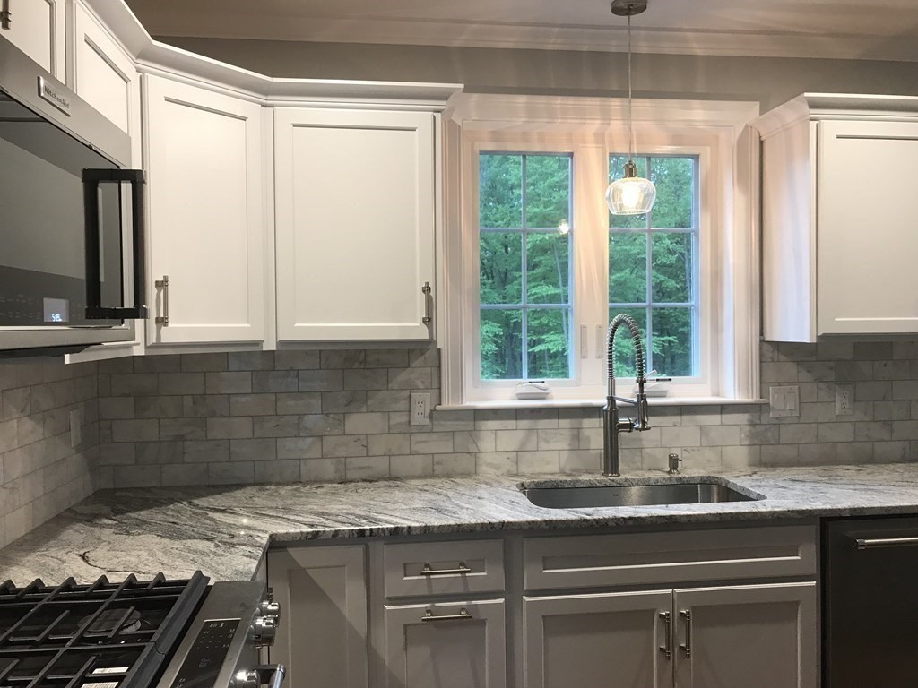291 River Road Hudson, MA 01749 - Photo 4 of 12 a kitchen with a sink stove and cabinets