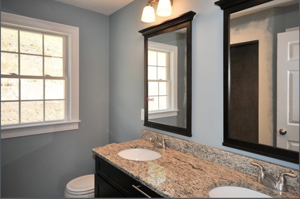291 River Road Hudson, MA 01749 - Photo 7 of 12 a bathroom with a granite countertop sink and a mirror