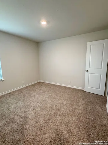a view of an empty room with a bathroom