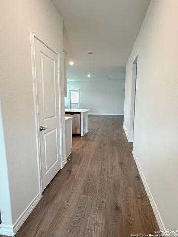 a view of a refrigerator in kitchen and wooden floor