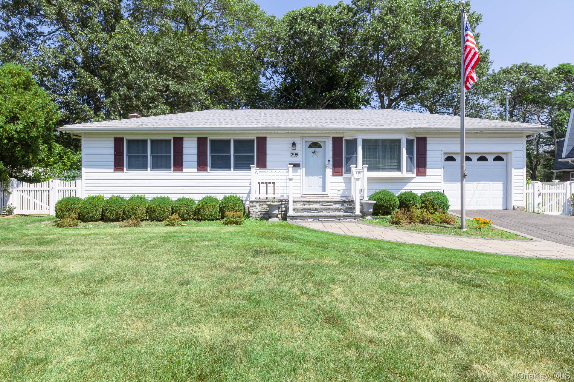 a front view of a house with a yard and porch