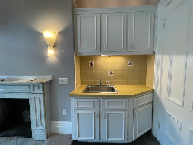 a kitchen with a refrigerator and a stove