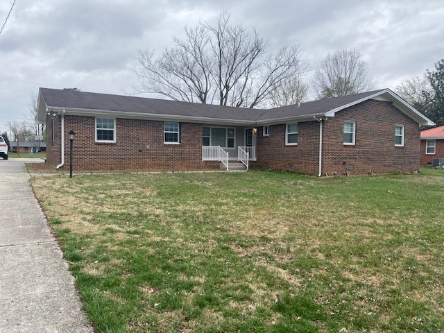 607 Adams Street Manchester, TN 37355 - Photo 2 of 14 a large house with a big yard and large trees