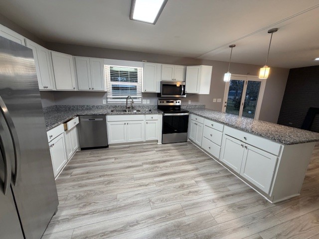 607 Adams Street Manchester, TN 37355 - Photo 3 of 14 a large kitchen with stainless steel appliances granite countertop a stove top oven a sink with granite countertops and cabinets