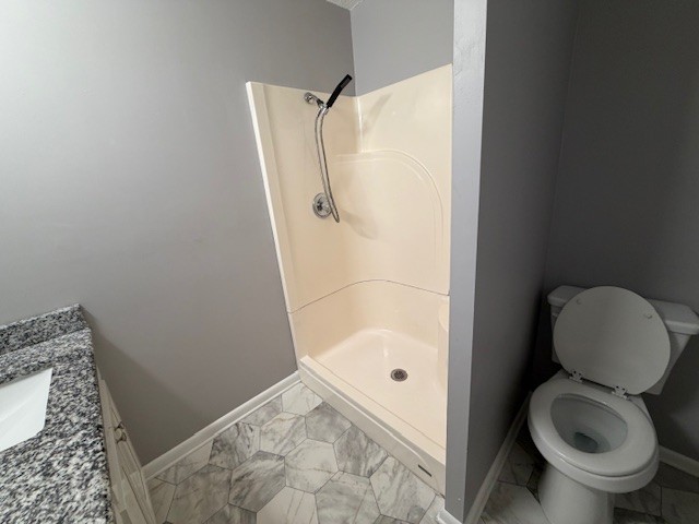 607 Adams Street Manchester, TN 37355 - Photo 9 of 14 a bathroom with a toilet and a shower